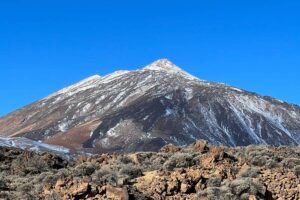 Mount Teide in Teide National Park, Tenerife, with volcanic landscape and clear blue sky.