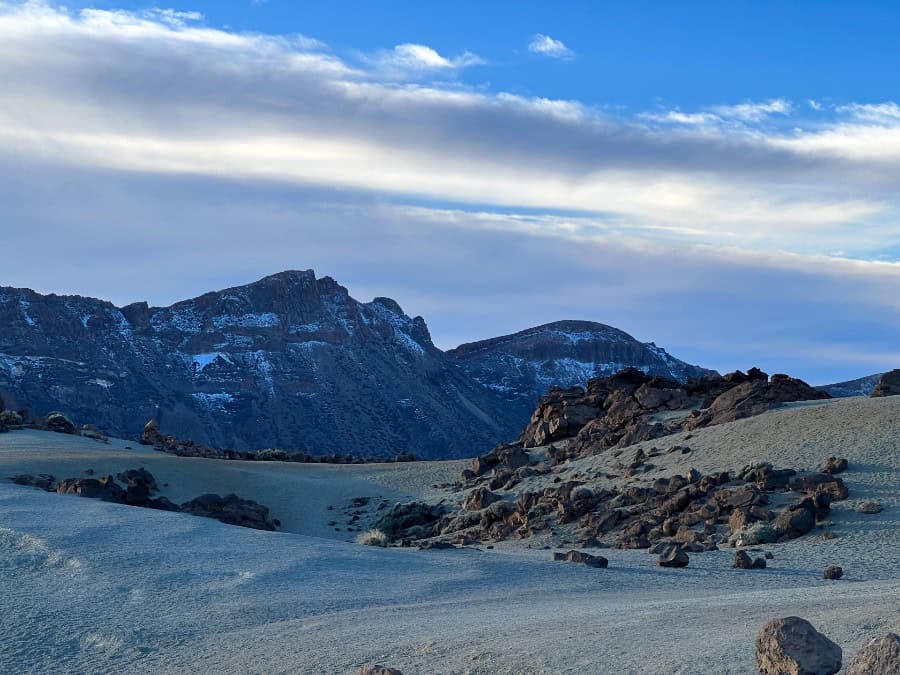 Pale volcanic landscape at Minas de San José in Teide National Park, Tenerife, with a car parked nearby.