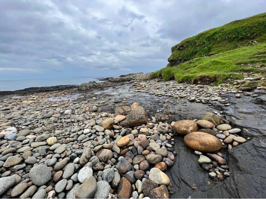 stream running under large stones