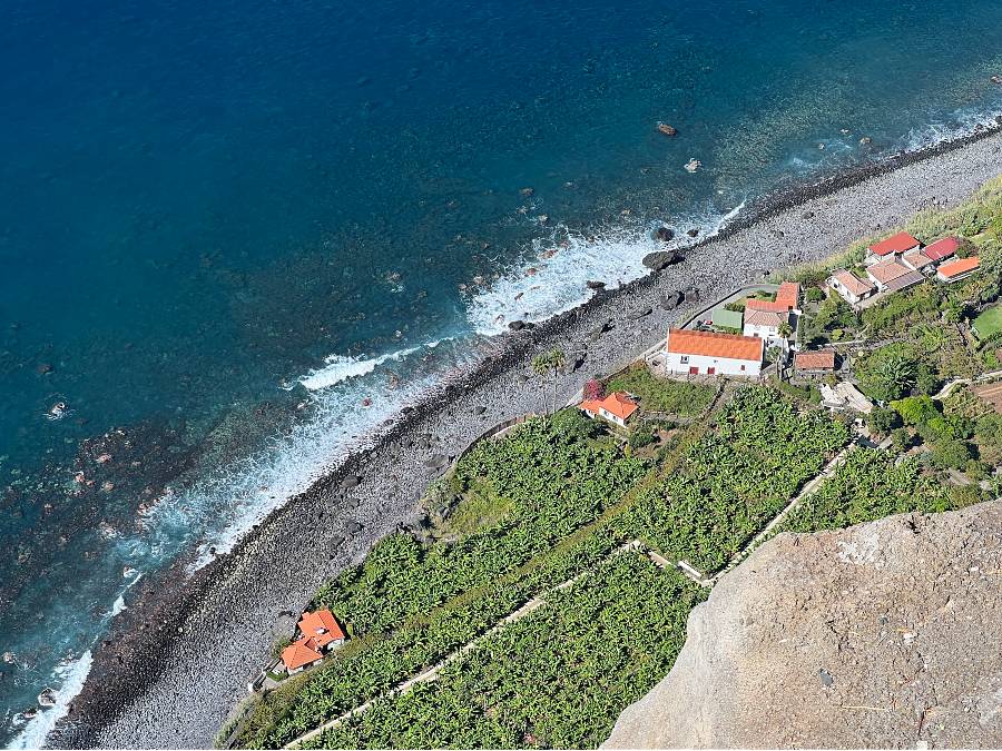 Cable car descending a cliff to Fajã dos Padres with subtropical gardens and ocean views in Madeira