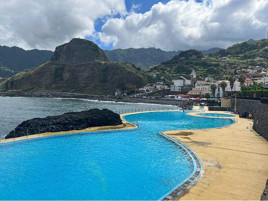 Natural swimming pools in Porto da Cruz with ocean views, volcanic rock, and green hills on Madeira’s north coast