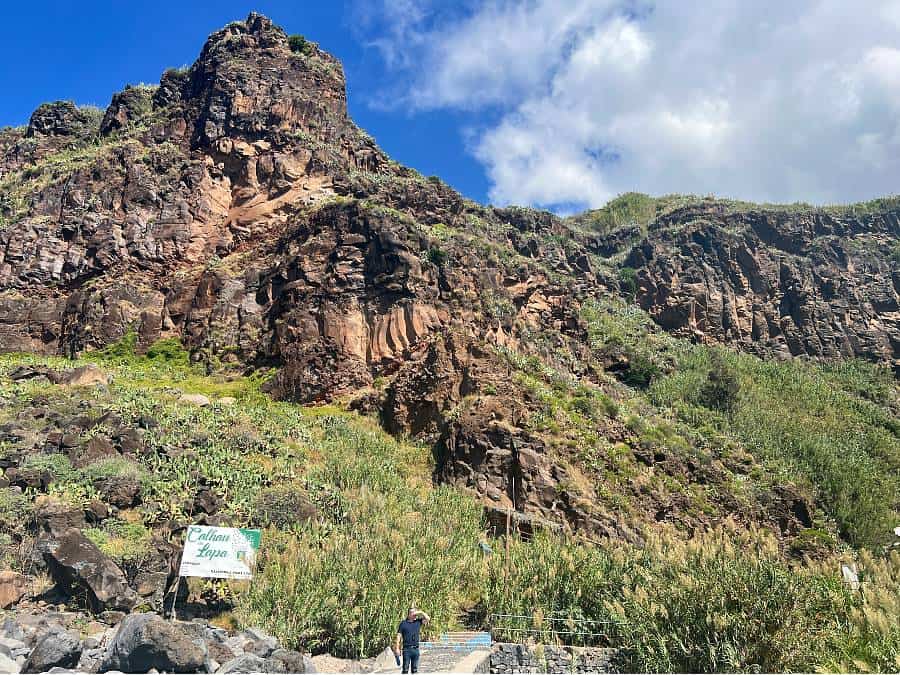 red volcanic cliffs and verdant landscape