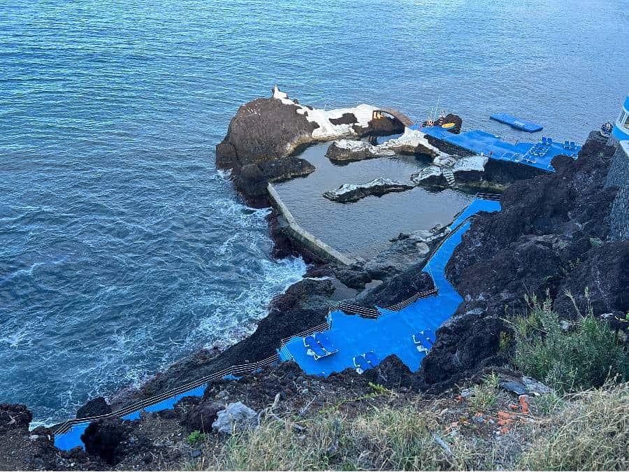 looking down onto a bathing complex with pools and rocks