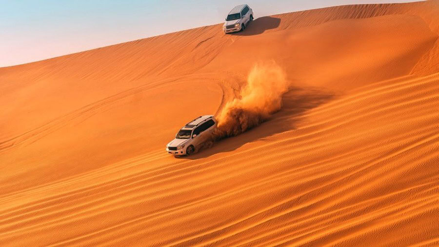a car dune bashing in the desert