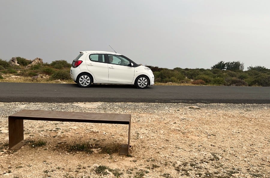 White Compact rental car booked through DiscoverCars for a road trip in Malta.
