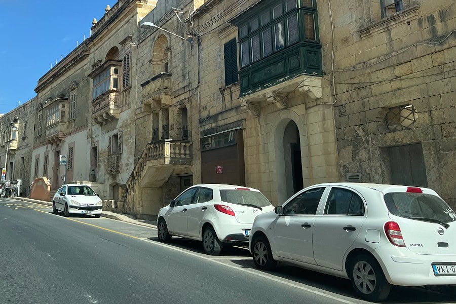Quiet street in Malta with historic stone buildings — a peaceful road trip stop perfect for slow mornings.