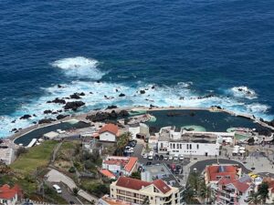 Porto Moniz volcanic pools in Madeira with enclosed lava rock basins, ladders, and Atlantic Ocean views