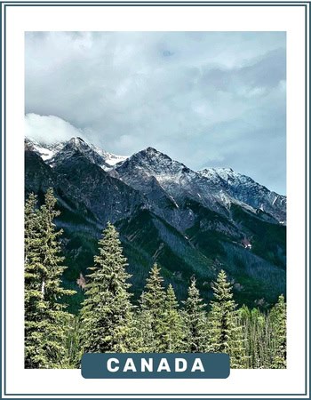 Green forest and snow-capped mountain terrain in Canada