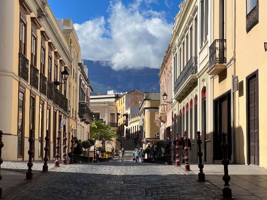 Cobbled street in La Orotava Tenerife with historic buildings, balconies and mountains in the background.