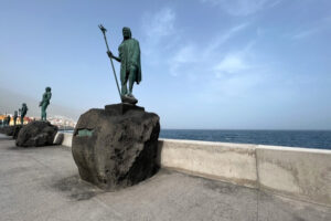 statues standing on large rocks along a Tenerife promenade.