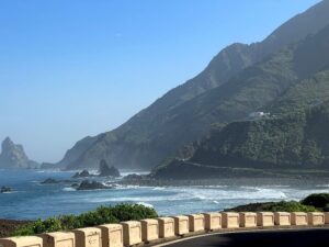 coastline along southern Tenerife with blue sky, ocean, and mountains.