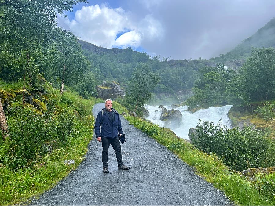 Wide walking path through the mountain valley towards Briksdalsbreen