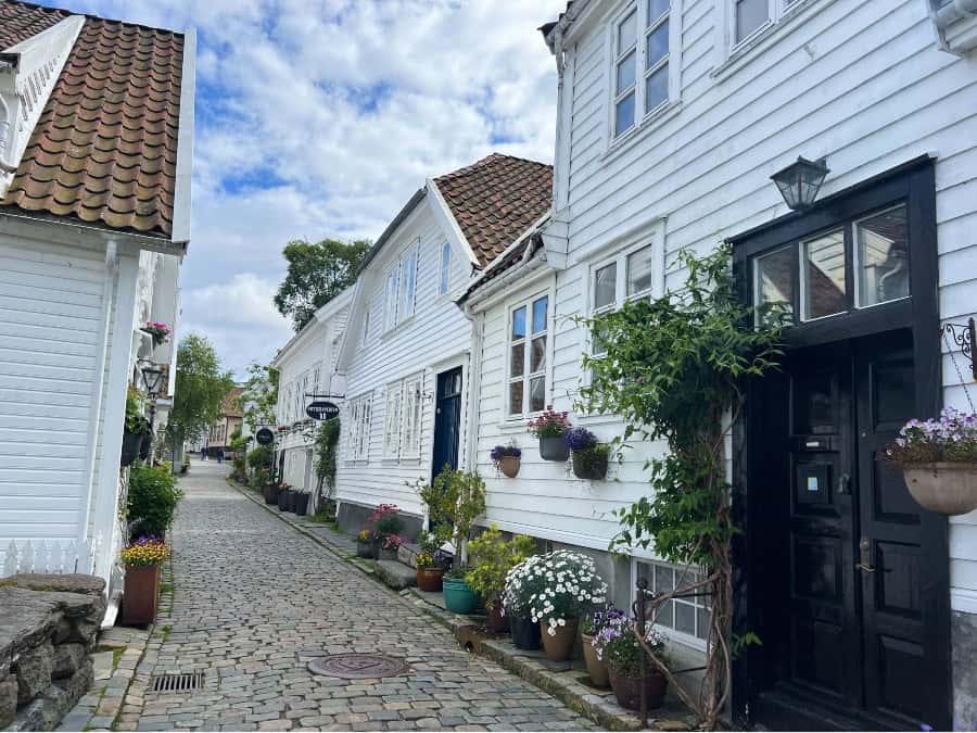 White wooden houses and flower-filled cobbled streets in Gamle Stavanger