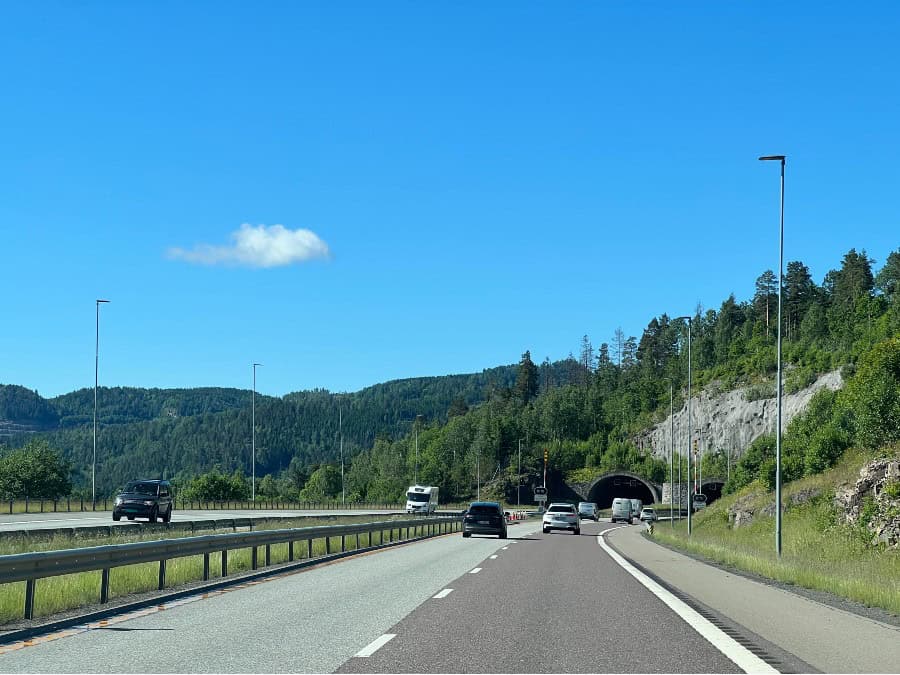 Wide main road leading towards a tunnel while driving in Norway