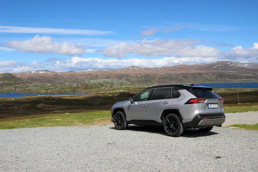 Rental car parked at a scenic viewpoint during a Norway road trip