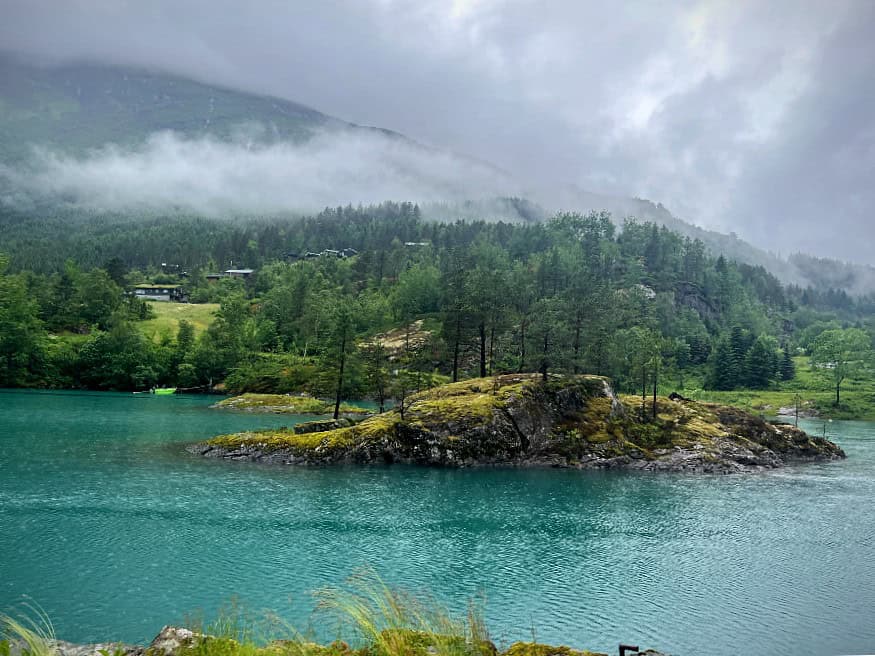 Narrow scenic road through Kjenndalen towards Kjenndal Glacier
