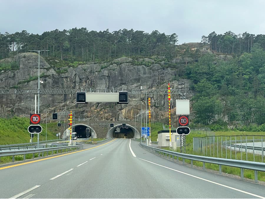 Main road leading into a tunnel cut through rock in Norway