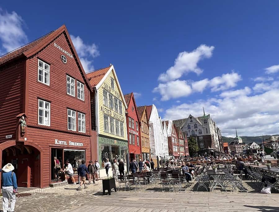 Bryggen in Bergen with colourful wooden buildings, restaurants and waterfront seating
