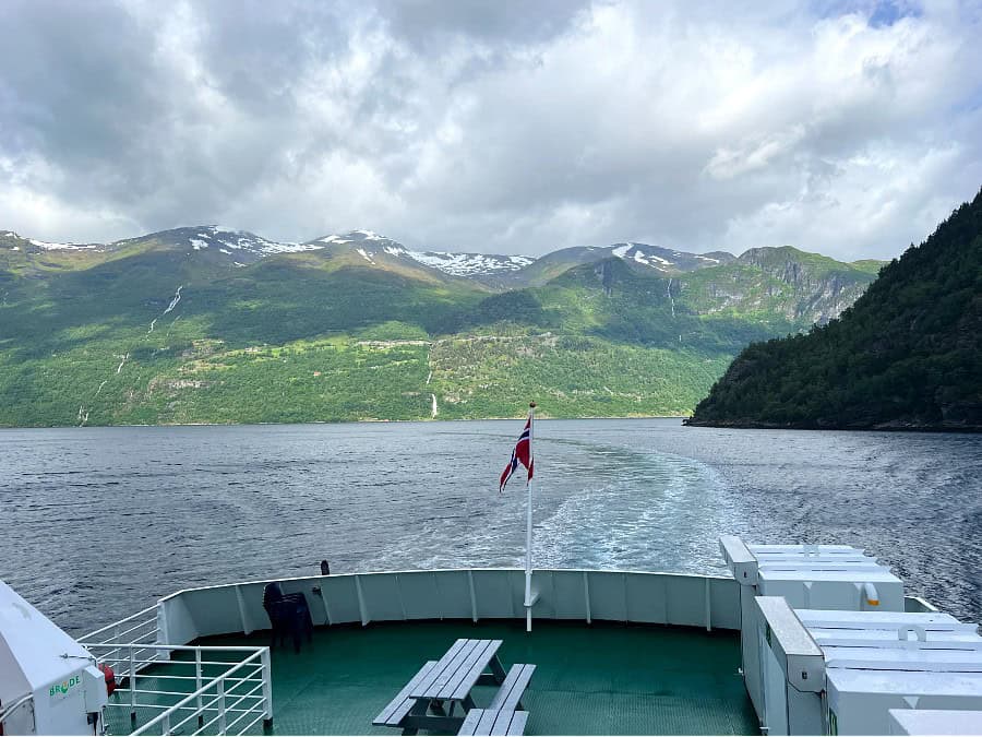 View from the Geirangerfjord car ferry with mountains, waterfalls and fjord scenery